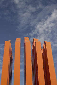 Orange sculpture of a skyscraper.