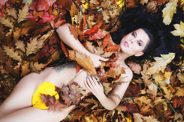 Beautiful woman in autumn leaves