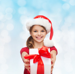 smiling girl in santa helper hat with gift box