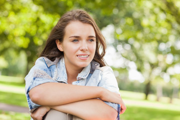 Fototapeta premium Pretty smiling student sitting on grass