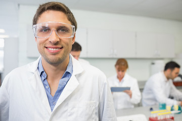 Fototapeta premium Smiling scientist with colleagues at work in the lab
