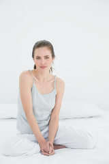 Portrait of a woman sitting in bed