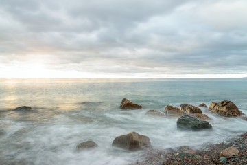 Fototapeta na wymiar Ocean waves at sunrise - Long-exposure