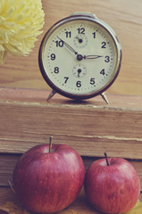 Vintage books with clock and apples