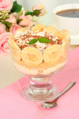 Delicious dessert with banana and caramel on table close-up