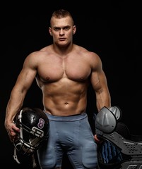 Man holding american football player accessories