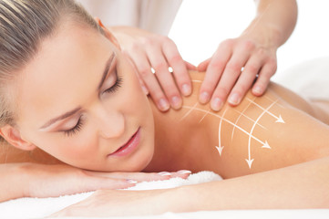 Obraz na płótnie Canvas A woman getting massaging treatment over white background