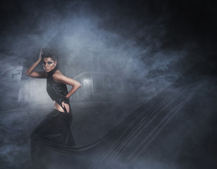 Fototapeta na wymiar Fashion shoot of a sexy woman in a black long dress