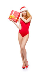 Beautiful, young and sexy Santa girl in Christmas swimsuit