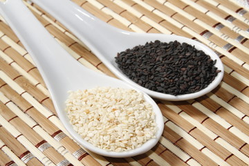 black and white sesame seeds on ceramic spoon