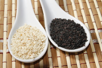 black and white sesame seeds on ceramic spoon