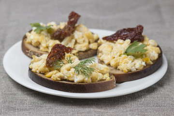 Scrambled eggs on toasted rustic bread