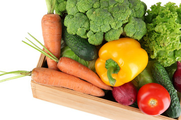 Fresh vegetables in wooden box on grey background