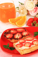 Delicious toast with strawberry on plate close-up