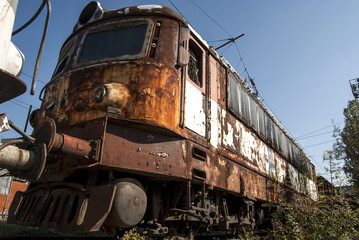 Fototapeta na wymiar Abandoned vintage rusty grungy electric locomotive