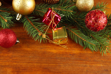 Beautiful Christmas decorations on fir tree on wooden