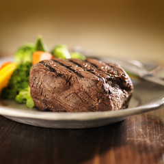 grilled steak on plate with vegetables