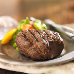 grilled steak on plate with vegetables