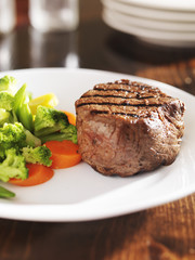 grilled steak on plate with vegetables