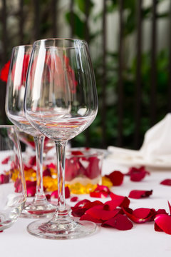 Wine glass table set with rose petals decorations