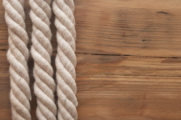 Fototapeta na wymiar Ropes on a wooden background