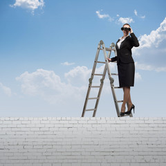 businesswoman looking through binoculars