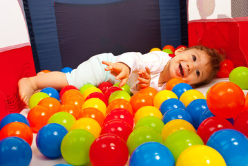 Happy baby playing with balls