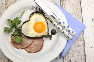 Protein breakfast of ham and eggs on shabby chic table