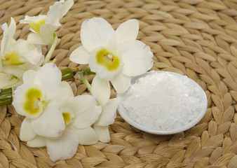Fototapeta na wymiar Branch white orchid on woven mat background