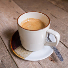 Cup of hot coffee on wooden table