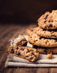 Chocolate chip cookies on natural linen napkin on wooden backgro