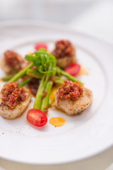 Grilled scallops on white plate
