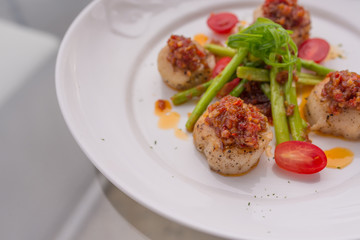 Grilled scallops on white plate