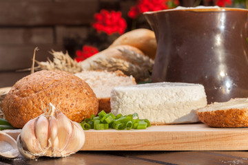 Fototapeta premium Country breakfast consisting of bread, cheese, milk and garlic.