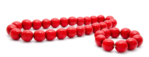 Red wooden beads and bracelet on a white background