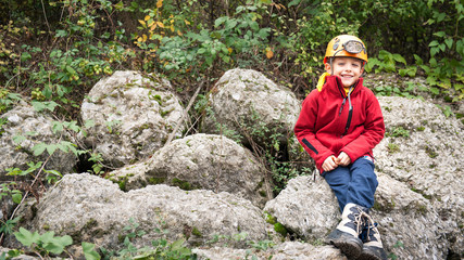 Young kid portrait with helmet for cave exploration.