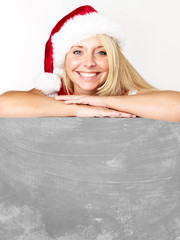 Women with santa hat presenting message board