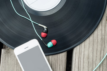 Color Headphones, phone and vinyl on wooden floor
