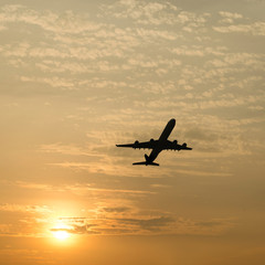 Fototapeta na wymiar Silhouette of an airplane with sunset sky