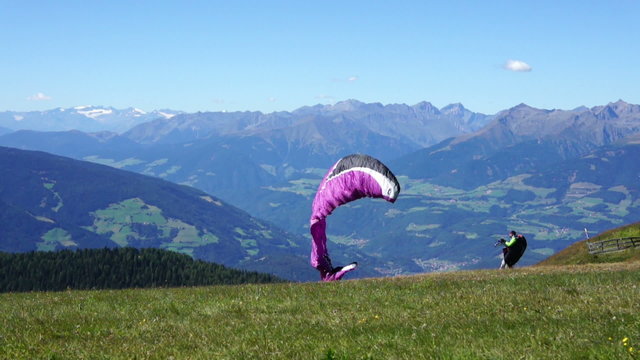 Paraglider taking off from a mountain - start, Kronplatz, Italy