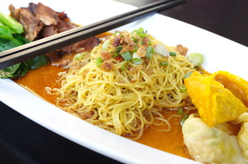 Egg chinese dry noodles with roast pork, dumpling
