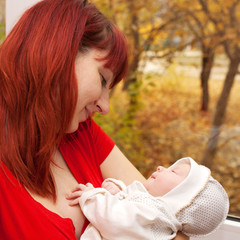 Obraz premium Mother and newborn baby looking and smiling.