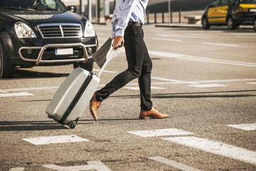 Businessman crossing the street. Goes to the convention.
