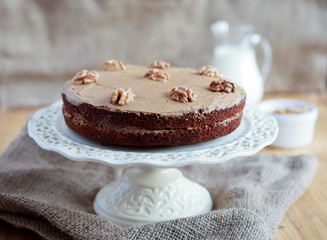 Homemade coffee and walnut cake on a stand, selective focus