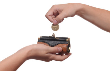 Hand puts a coin in the purse, isolated on white background