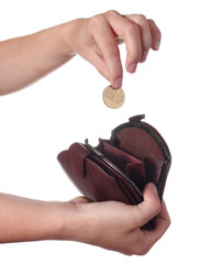 Hand puts a coin in the purse, isolated on white background