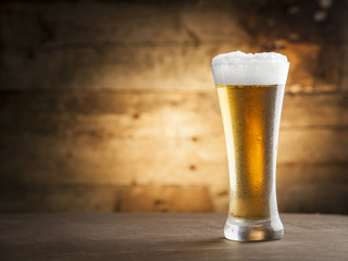 Glass of beer over a wooden background