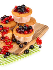Tasty muffins with berries isolated on white