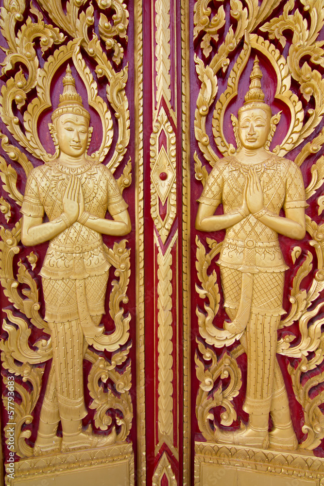 Wall mural Wood carving temple door in Thailand