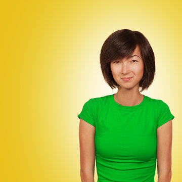 Portrait of a smiling woman on a bright yellow background
